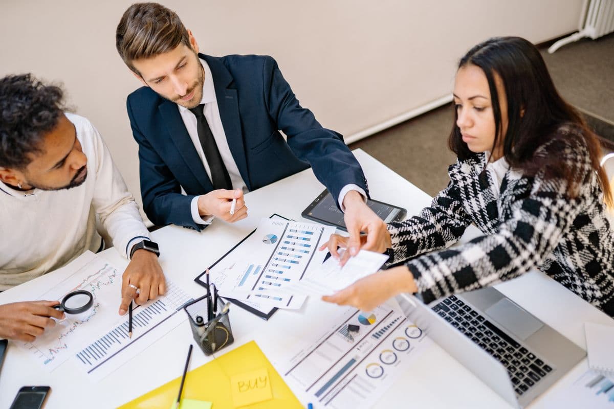 Colleagues working through paperwork and plans together at a desk