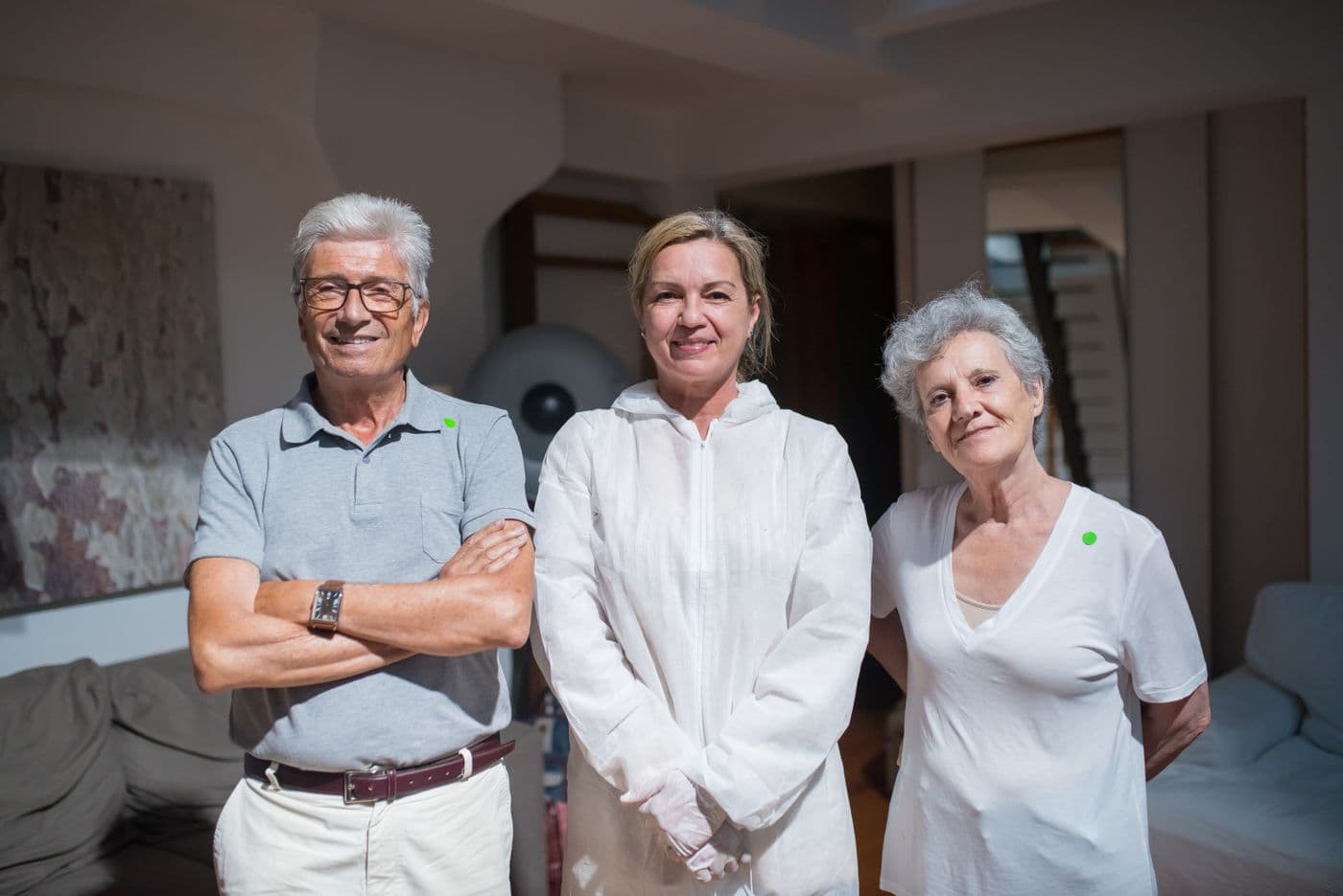 Three members of a care team standing together in a client's home