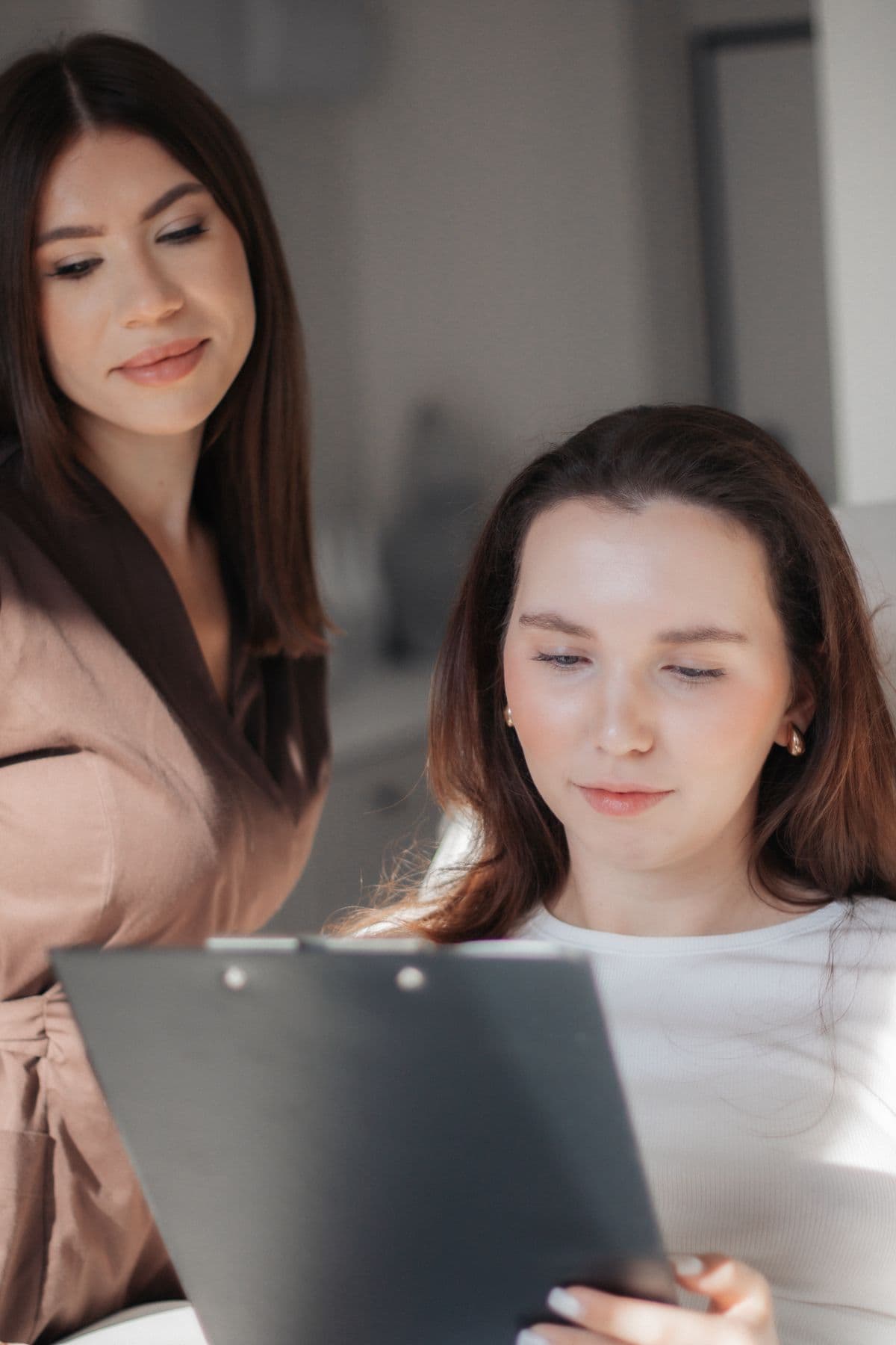 Two colleagues reviewing figures on a tablet together